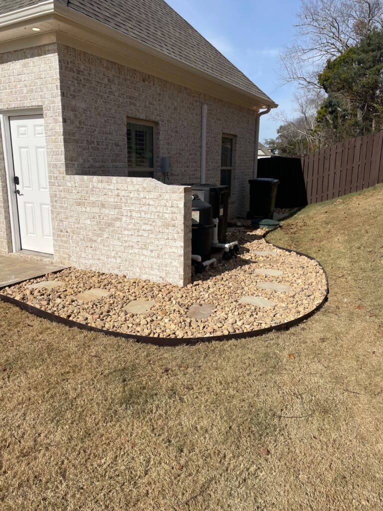 River rock bed by PHES Landscaping