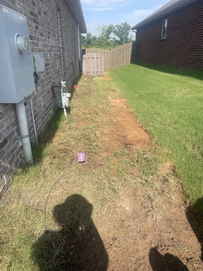 Before — bare dirt backyard